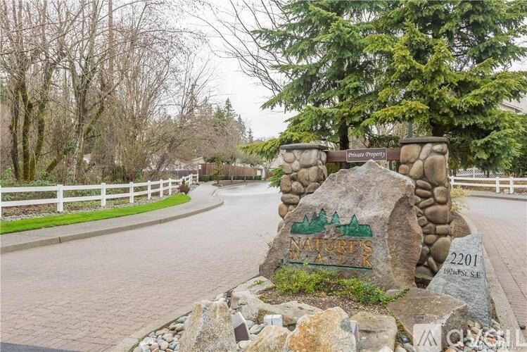 A stone with the word "Murray's" written on it is in the foreground of a paved road.