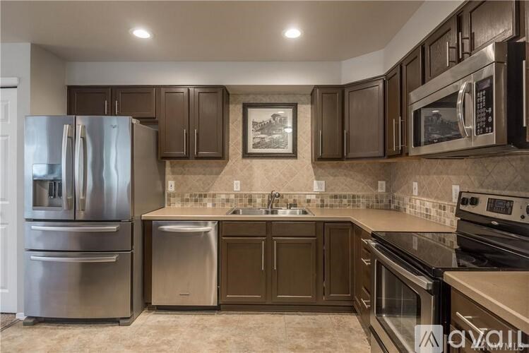 A kitchen with brown cabinets and stainless steel appliances.