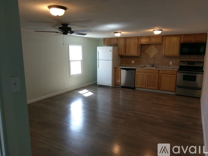 A kitchen with wooden cabinets and a white refrigerator.
