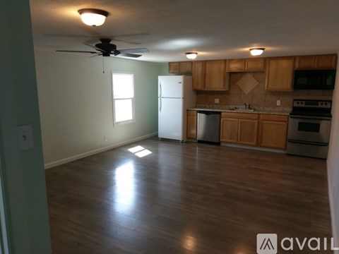 A kitchen with wooden cabinets and a white refrigerator.