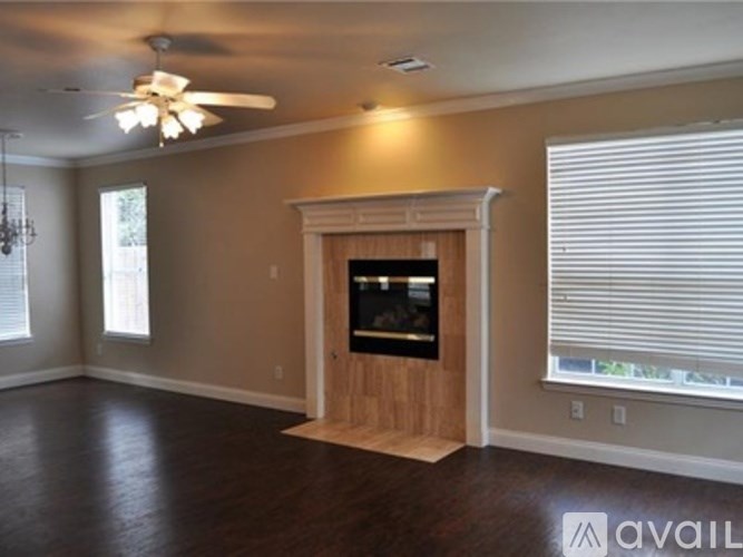 A room with a fireplace and a ceiling fan.