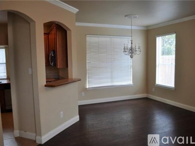 A room with a wooden counter and a chandelier.