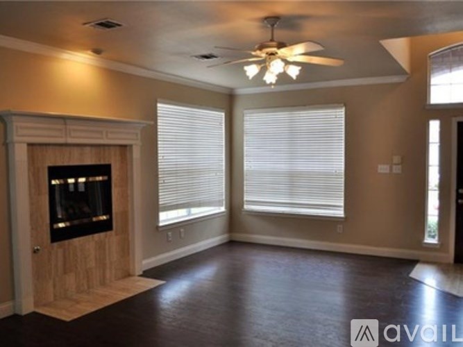 A living room with a fireplace and a television.