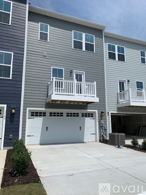A two-story building with a balcony on the second floor.