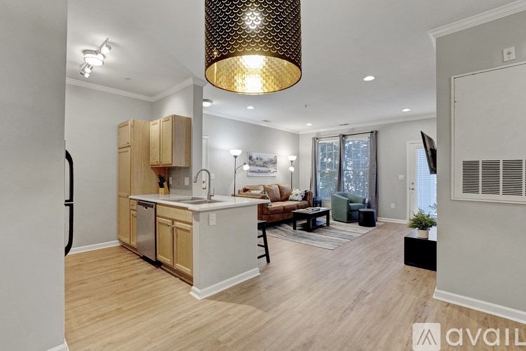 A modern kitchen with wooden cabinets and a large island.