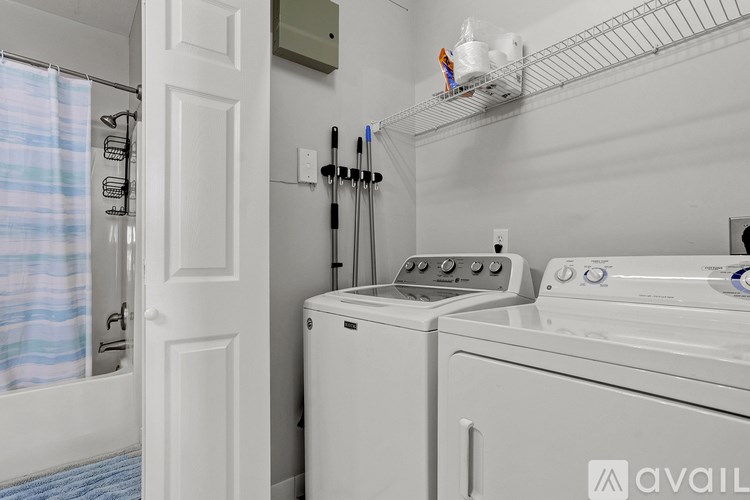 A white washer and dryer in a small laundry room.
