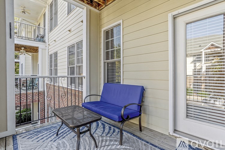 A balcony with a blue chair and table.