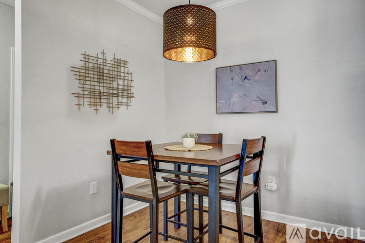 A dining room with a wooden table and chairs.