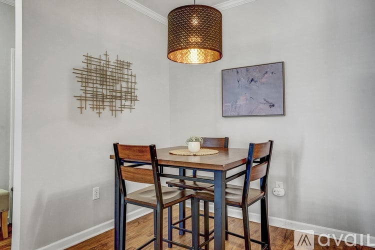 A dining room with a wooden table and chairs.
