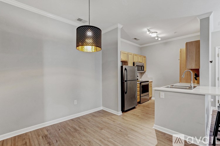 A kitchen with a refrigerator, microwave, and oven.
