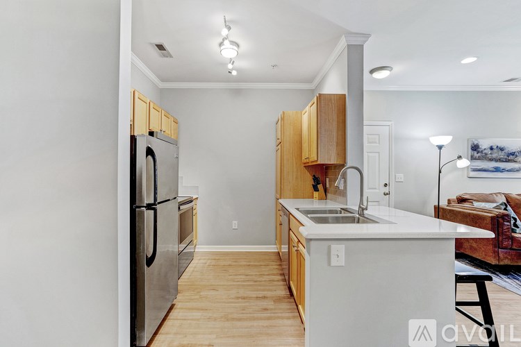 A kitchen with wooden cabinets and a white sink.
