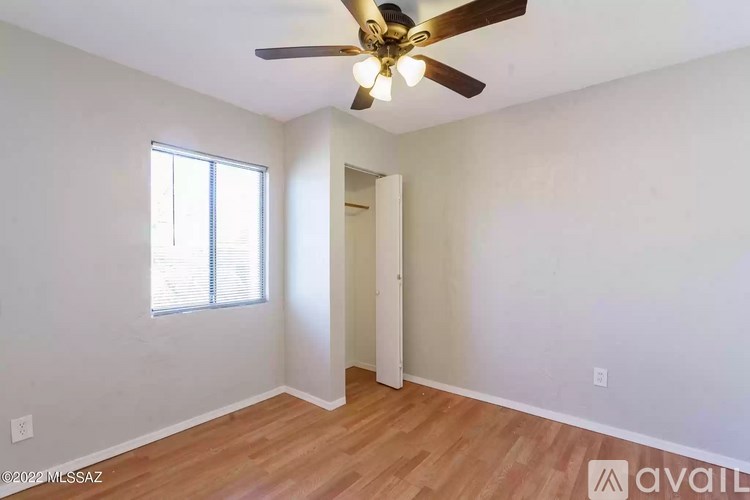 A room with a ceiling fan and a window.