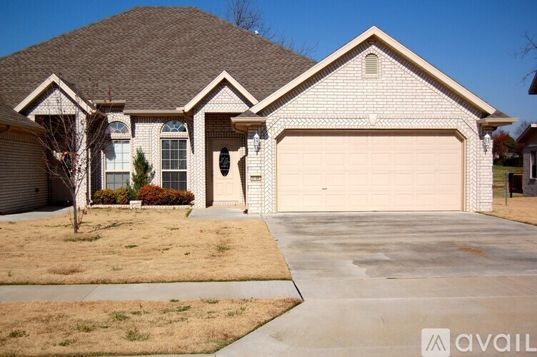 A house with a garage and a driveway in front.
