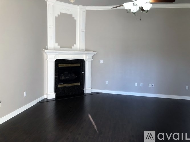 A room with a fireplace and a ceiling fan.