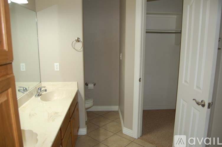 A bathroom with a sink, mirror, and toilet.
