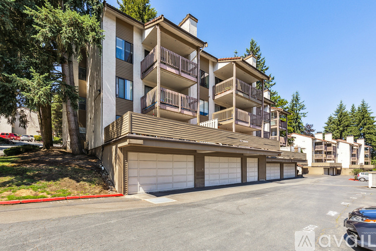 A large apartment building with a parking lot in front.