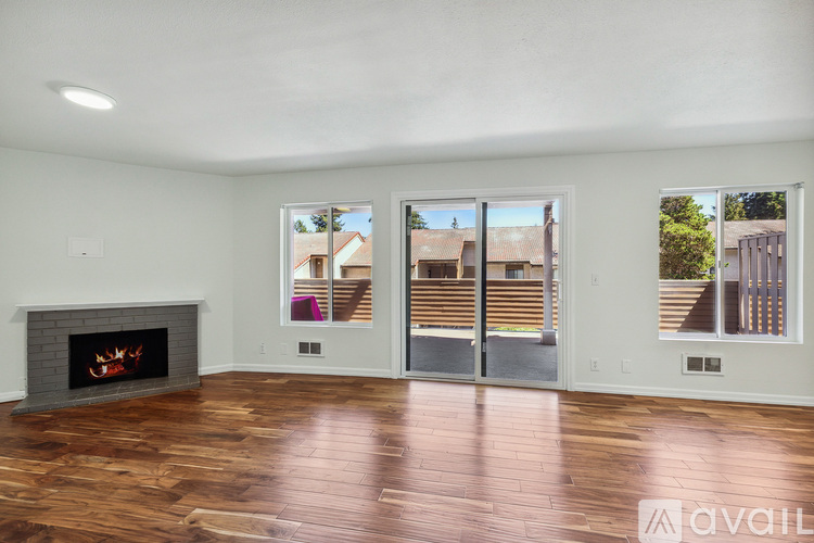 A living room with a fireplace and sliding glass doors.