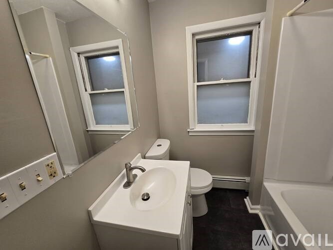 A bathroom with a sink, toilet, and bathtub.