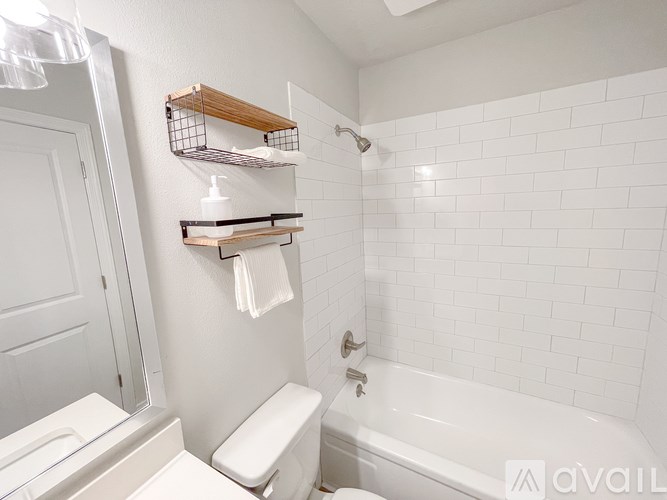 A white bathroom with a toilet, sink, and bathtub.