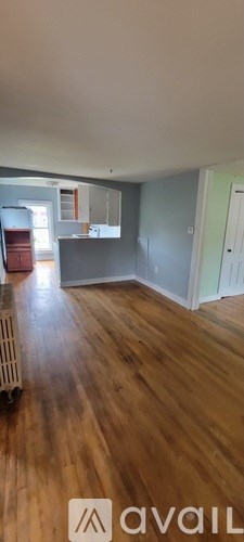 A room with wooden flooring and a white ceiling.