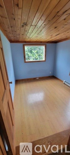 A room with wooden floors and a window.