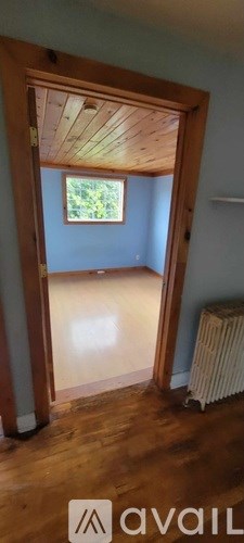 A room with wooden floors and a window.