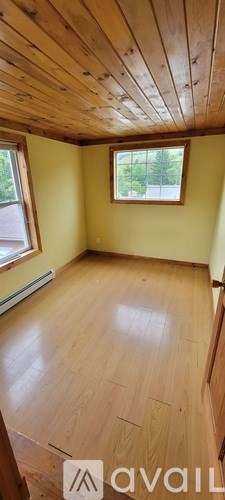 A room with wooden floors and a window.