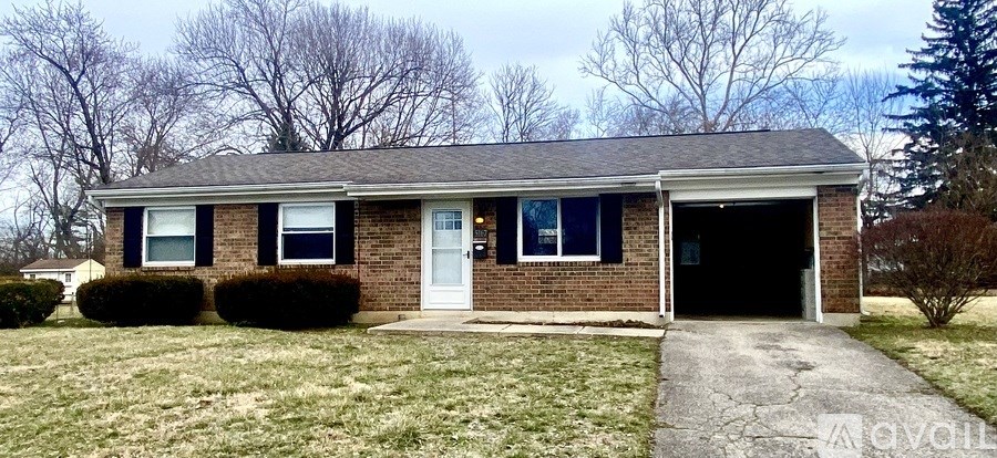 A brick house with a white door and windows.