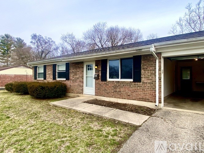 A house with a white door and a brick wall.
