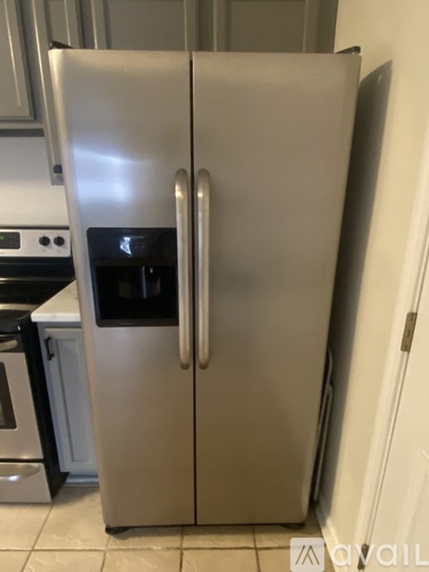 A silver refrigerator with its door open in a kitchen.