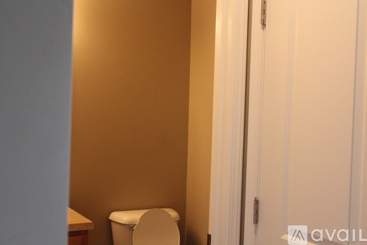 A white toilet in a small room with a white door.
