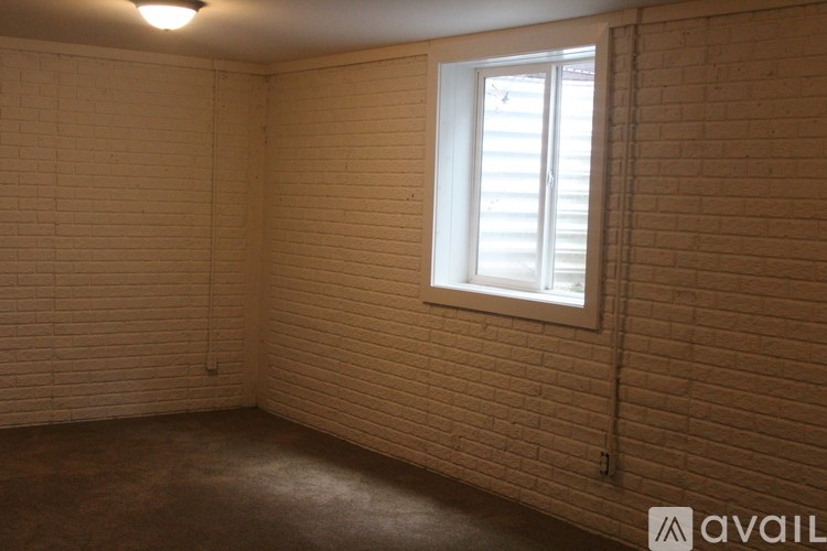 A room with a window and a white frame.