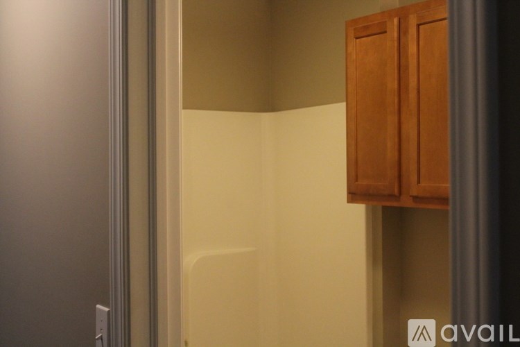 A wooden cabinet is mounted on a wall.