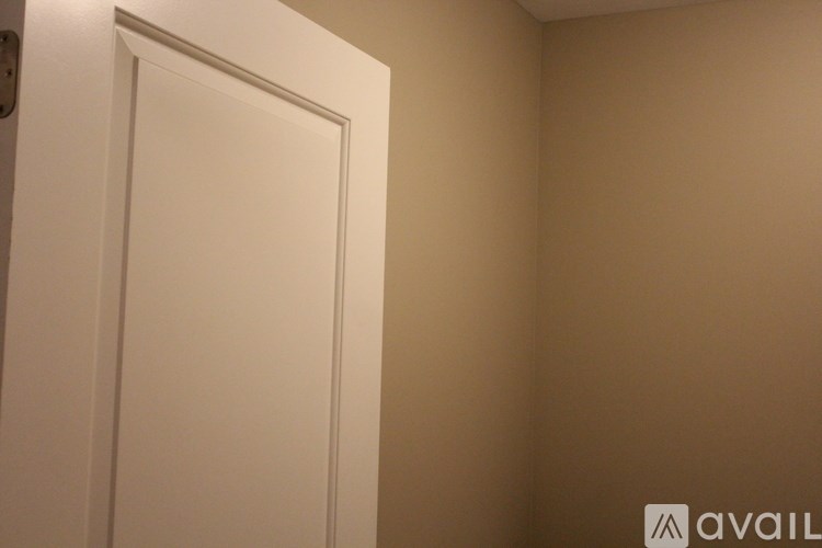 A white door in a room with beige walls.