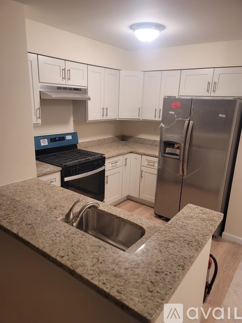 A kitchen with granite countertops and stainless steel appliances.