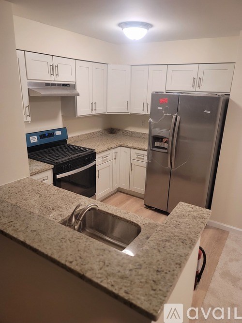 A kitchen with granite countertops and stainless steel appliances.