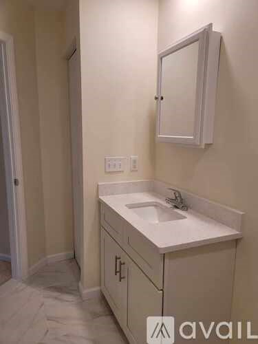A bathroom with a sink and a mirror.