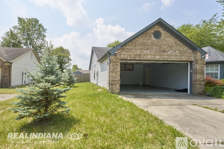 A brick house with a garage is for sale in Indiana.