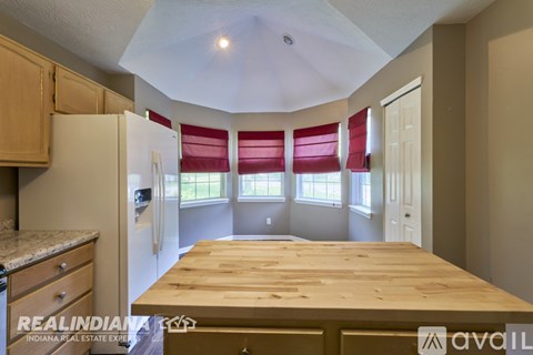 A kitchen with a table and chairs in the middle of the room.