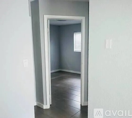 A room with a doorway leading to another room.