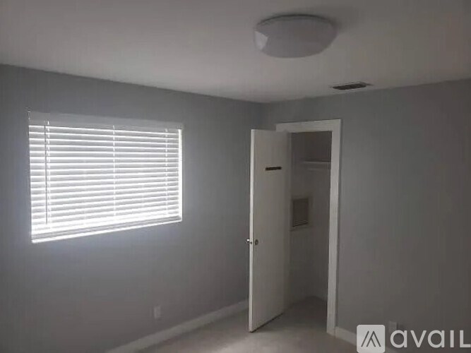 A room with a window and a door.