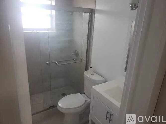 A white toilet and sink in a small bathroom.