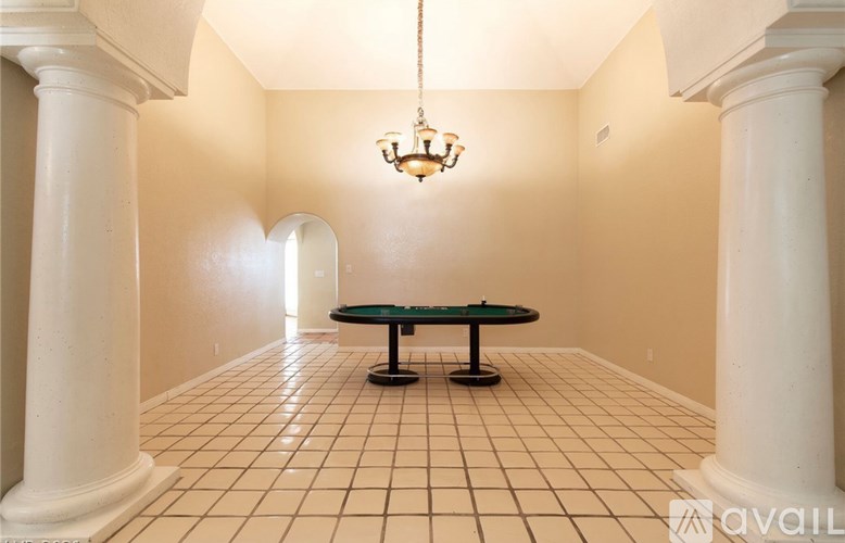 A room with a table and chairs in the middle.