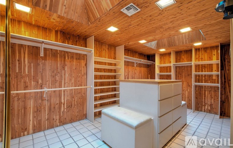 A room with wooden walls and a white cabinet.