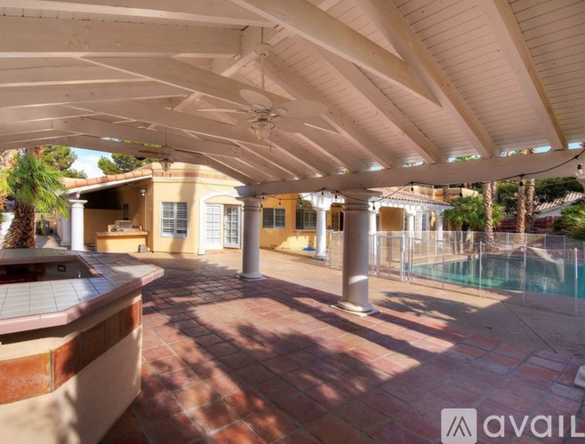 A patio with a pool and a hot tub.