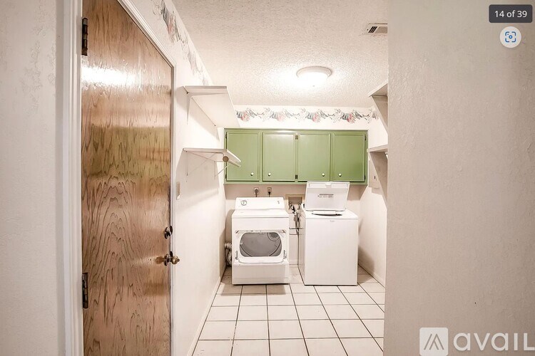 A small bathroom with a toilet, sink, and washing machine.