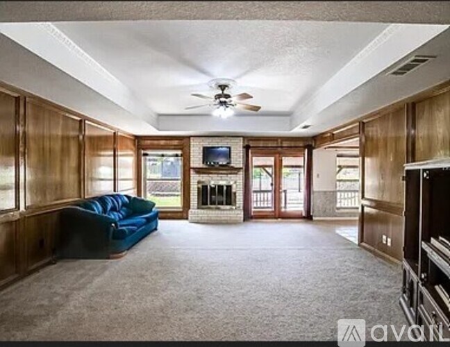 A living room with a blue couch and a television.