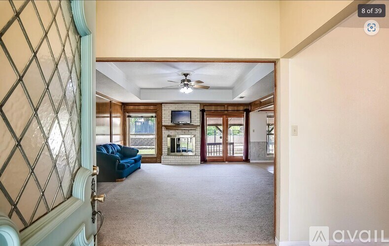 A living room with a blue sofa and a television.
