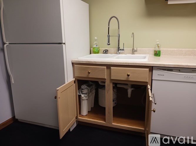 A small kitchen with a sink and a refrigerator.