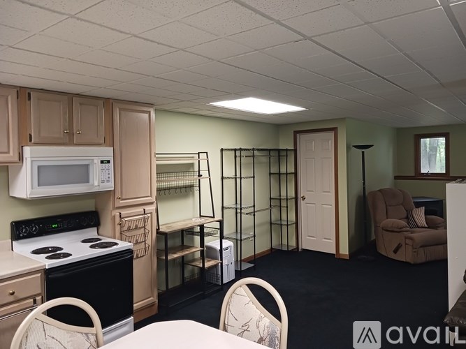 A kitchen with a stove, microwave, and refrigerator.